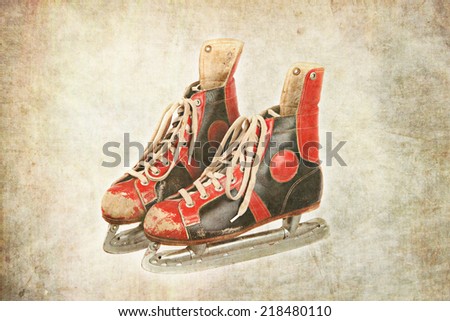 pair of used old ice skates, red and black colored, textured background, retro, vintage,