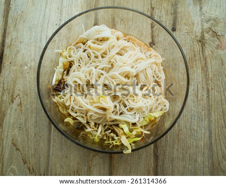 Thai vermicelli eaten with curry and vegetable on old wood table,Thai vermicelli eaten with curry,noodle,boiled Thai rice vermicelli, usually eaten with curries or Thai style
