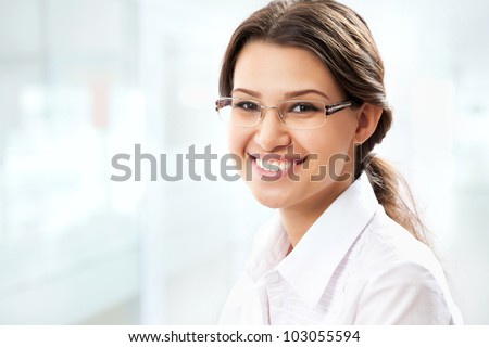 Young business woman giving you attractive smile