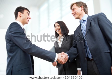 Business people shaking hands in modern office