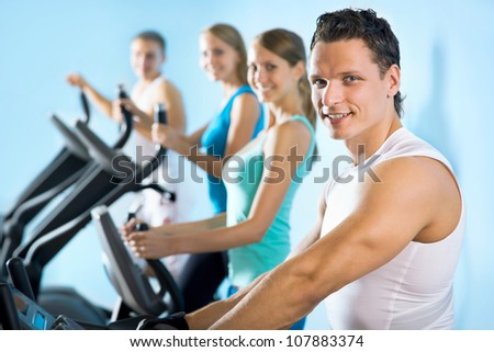 Young attractive people on the treadmill. Fitness