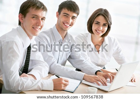 Portrait of a group of business people working together at a meeting