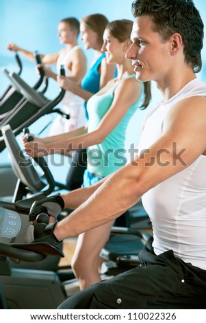 Young attractive people on the treadmill. Fitness