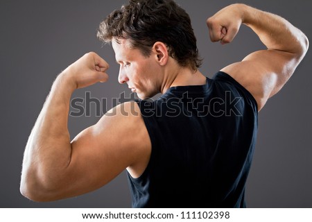Young and fit male model posing his muscles
