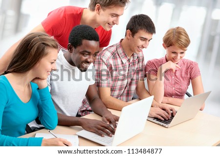 Group of young students studying together in a college