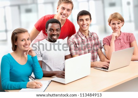 Group of young students studying together in a college