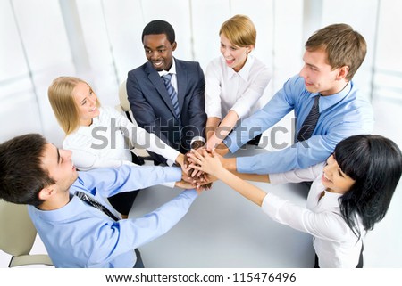 International  business team showing unity with their hands together