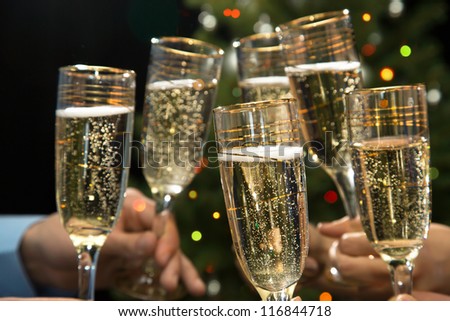 Image of people hands with crystal glasses full of champagne