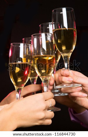 Image of people hands with crystal glasses full of champagne