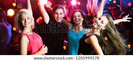 Group of happy young people having fun dancing at party.