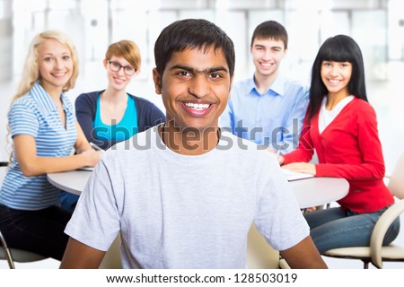 Young indian student and his diversity friends on background
