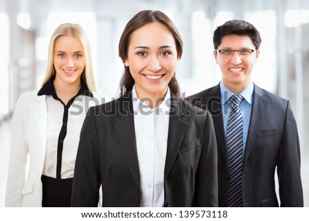 Happy business people with their female leader on the foreground