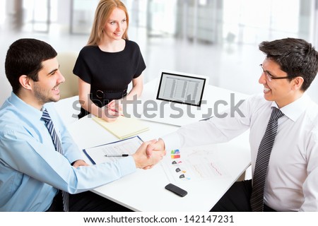 Friendly handshake business people in the office