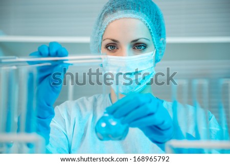 Attractive Young Scientist Observing The Blue Indicator Color Shift In The Glass Tube