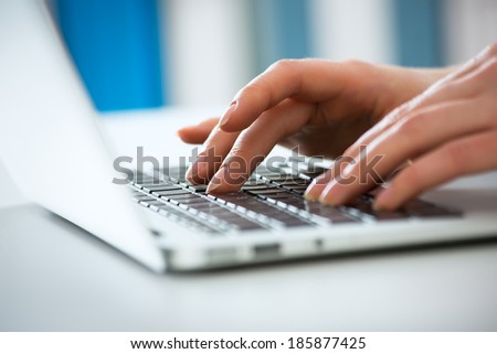 Closeup of businesswoman typing on laptop computer