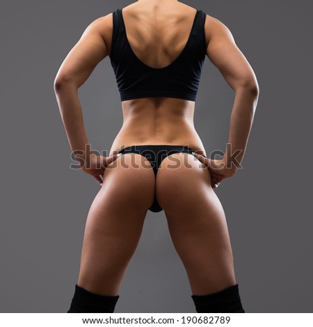 Back of fitness woman. Slim woman with dumbbells.