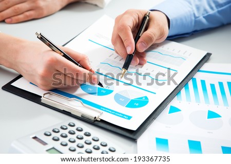 Close-up of businessman explaining a financial plan to colleagues at meeting