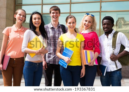Group of diverse students outside smiling together