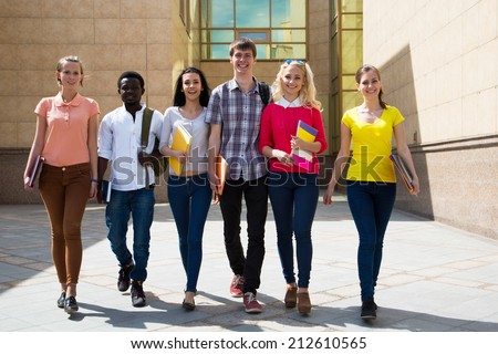 Group of diverse students outside walking together