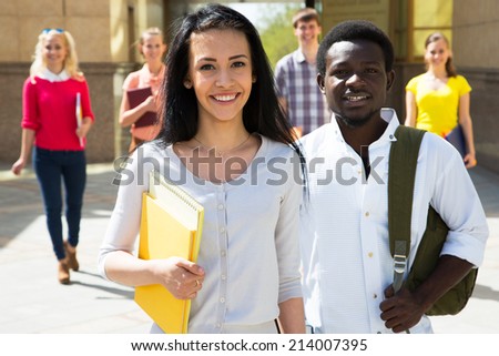Group of diverse students outside smiling together