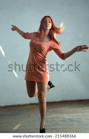 Beautiful young woman dancing in the old hall