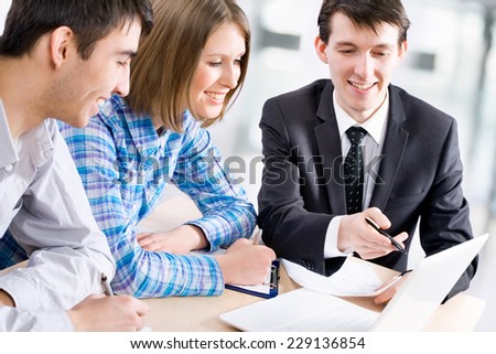 Manager talks to a young couple in the bank