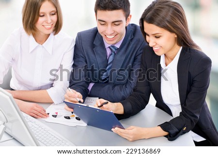 Teamwork - Business man showing something on computer screen to colleagues