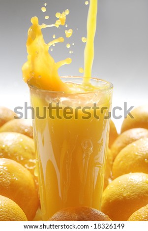 Image of glass of orange juice with fruits near by Image of glass of orange juice with fruits near by