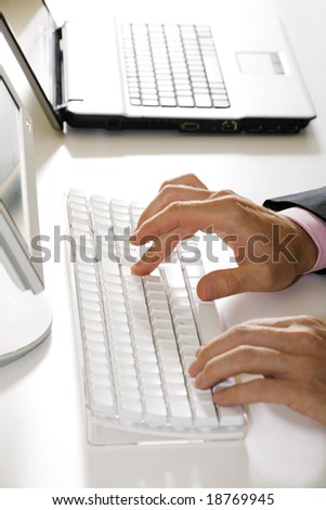Vertical image of human hands doing some computer work