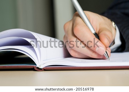 Close up of a hand of the writing businessman