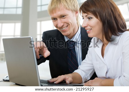 Two business people using laptop