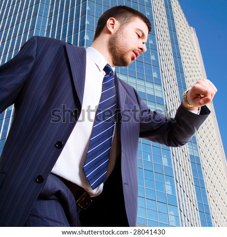A hurrying up businessman looking at his wrist watch