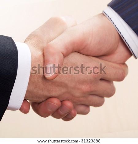 One man shakes another man by the hand