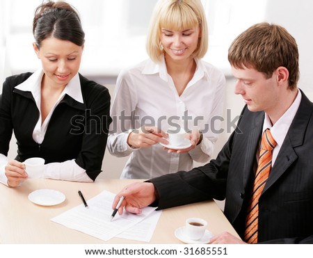 Portrait of business team sitting around table and discussing new plan