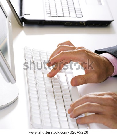 Vertical image of human hands doing some computer work
