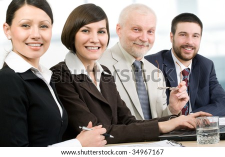 Four business people sitting in a row