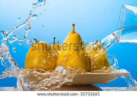Water pouring on yellow pears. Macro