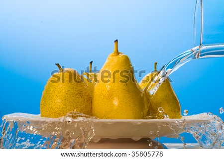 Water pouring on yellow pears.
