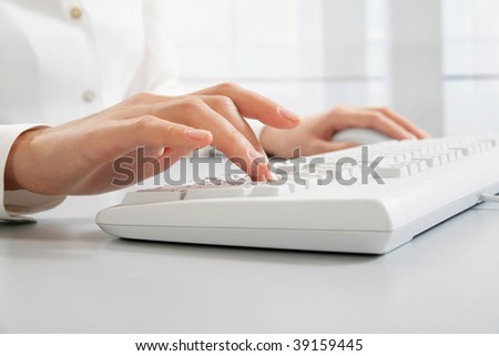 Human?s hand touching computer keys during work
