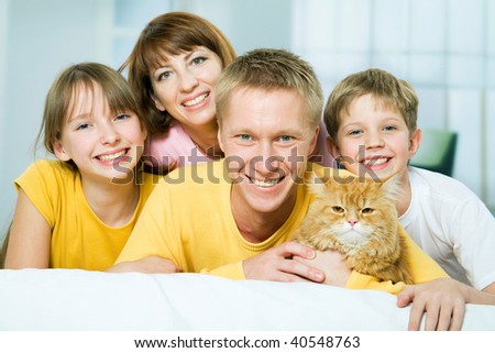 Portrait of a happy family with a house cat looking at camera