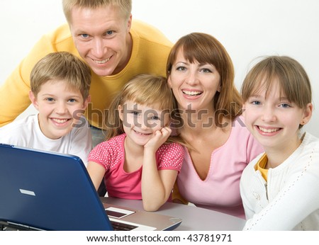 Family with laptop smiling