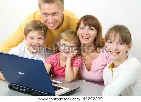 Family with laptop smiling
