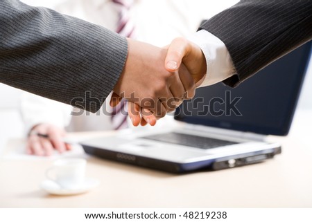 Close-up of hands shake between two successful business people