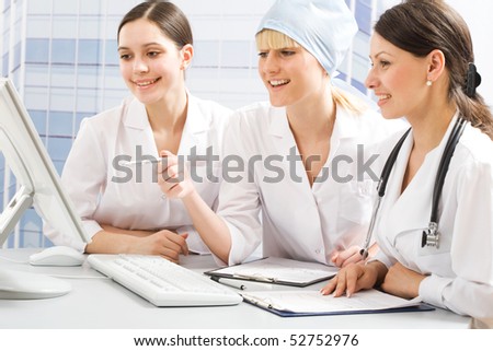 Three young female doctors working together