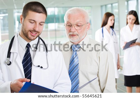 The young doctor talks to the patient