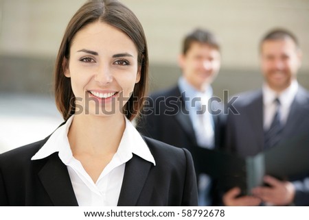 Beautiful woman on the background of business people