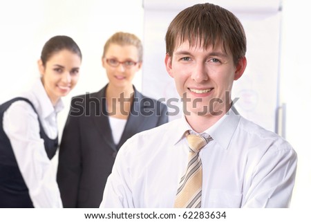 Portrait of businessman looking at camera in working environment