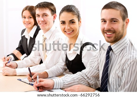 Image of four business people working at meeting