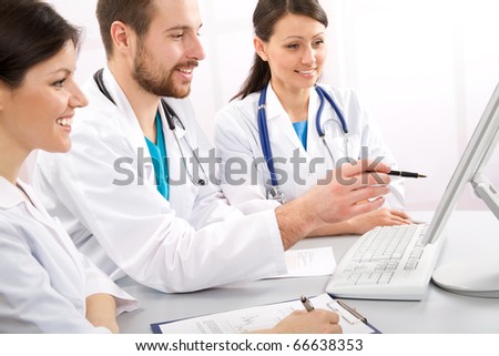Smiling medical doctors talk on a workplace