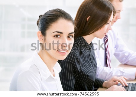 Portrait of successful businesswoman and business team at office meeting